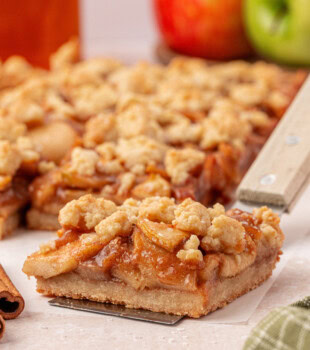 an apple pie bar with thick buttery crust and crumb topping