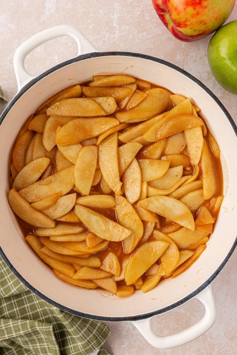 overhead view of partially cooked apple pie filling in a large pan