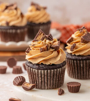 chocolate cupcakes with peanut butter frosting and hidden peanut butter filling and chopped candy garnish