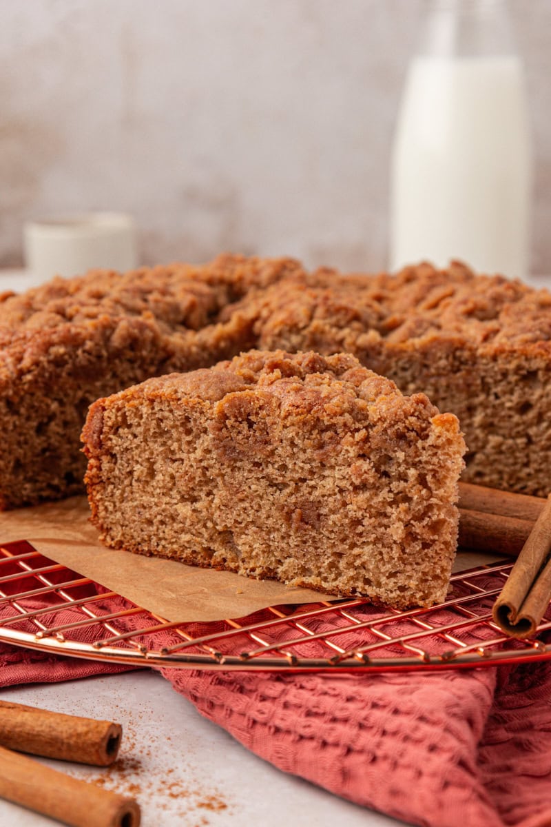 slice of cinnamon streusel muffin cake with streusel layered through the middle and on top
