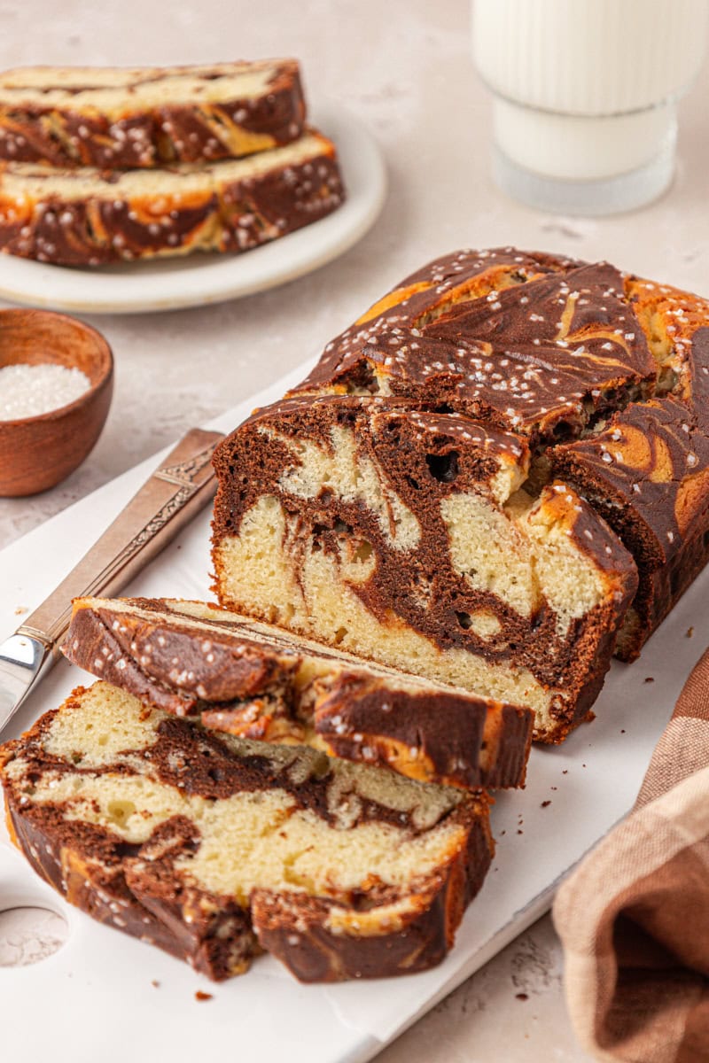 partially sliced marble loaf cake with chocolate and vanilla swirls