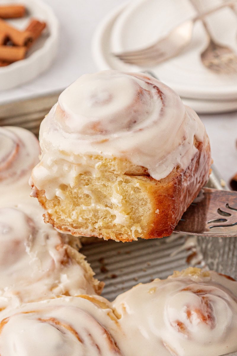 a soft, fluffy cinnamon roll topped with tangy cream cheese frosting