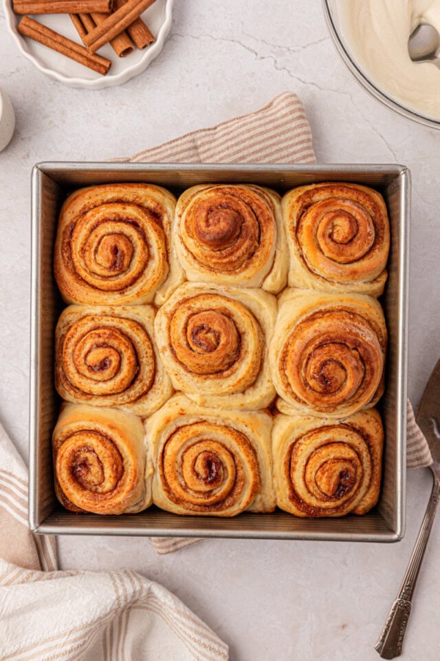 freshly baked cinnamon rolls in a square baking pan