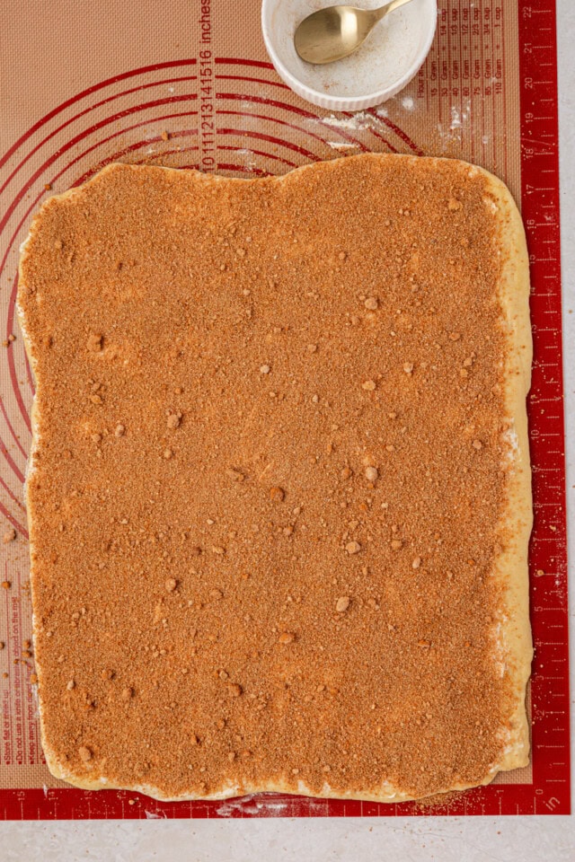 yeast dough rolled into a rectangle and covered in softened butter, brown sugar, and cinnamon