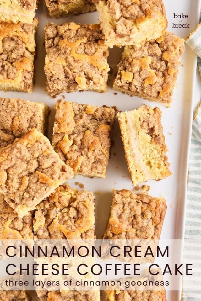sliced coffee cake with a layer of cinnamon cream cheese and a buttery crumb topping; text overlay "cinnamon cream cheese coffee cake - three layers of cinnamon goodness"