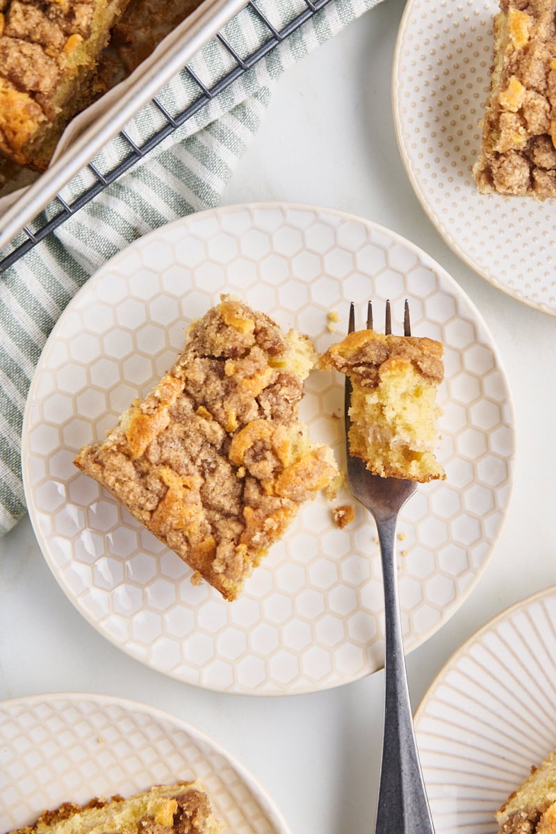 overhead view of cinnamon cream cheese coffee cake served on white plates