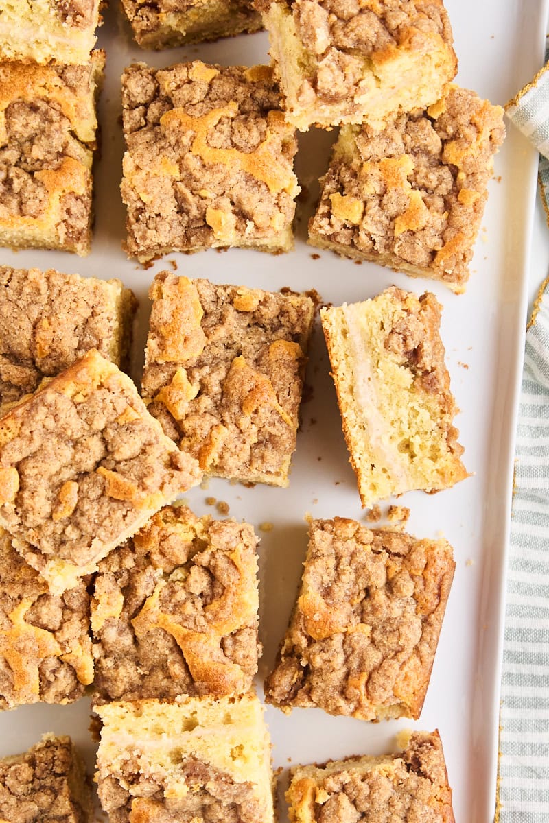 overhead view of slices of cinnamon cream cheese coffee cake with some on their sides to show the cream cheese filling