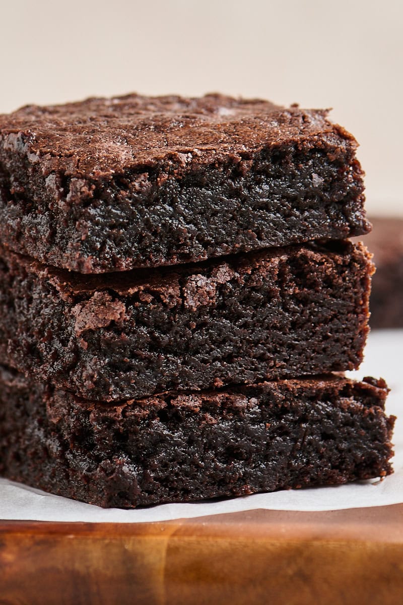 stacked brownies showing their fudgy centers and thin crinkly tops