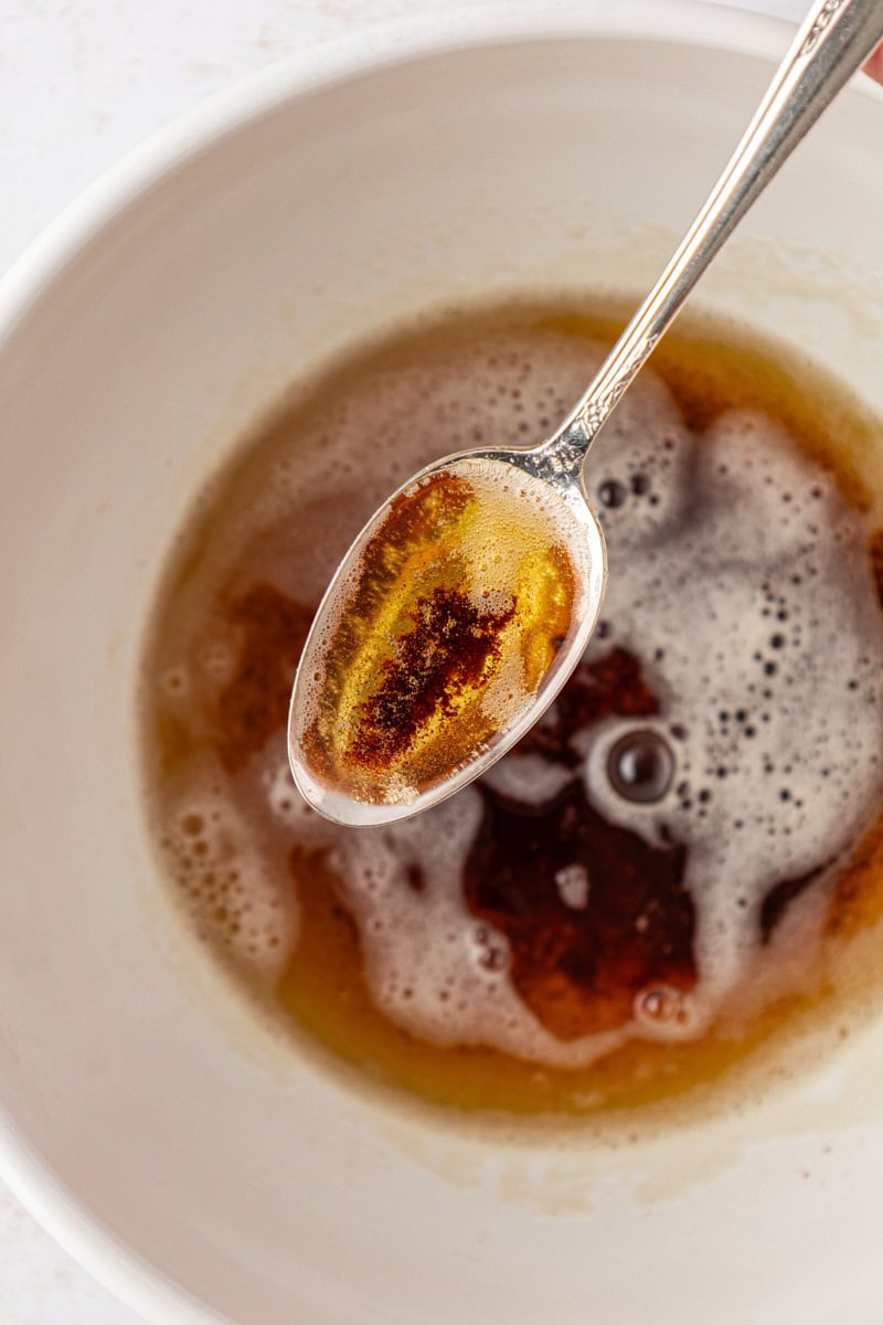 a spoonful of brown butter showing the amber color and browned milk solids