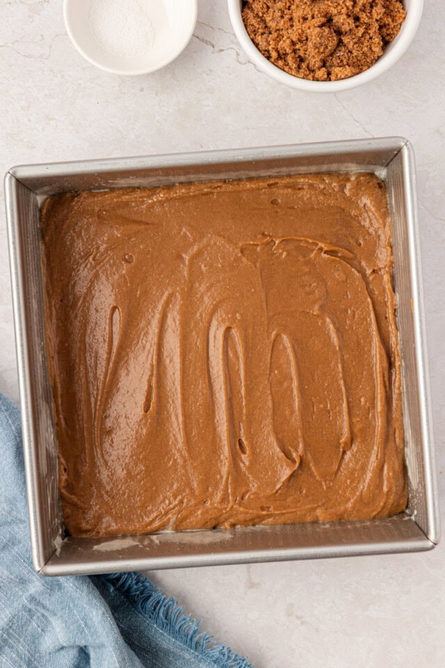 butterscotch cake batter spread in a square baking pan