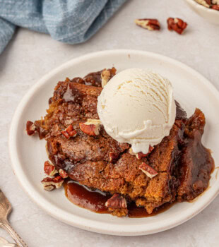 butterscotch pudding cake served with its own butterscotch sauce, ice cream, and toasted nuts