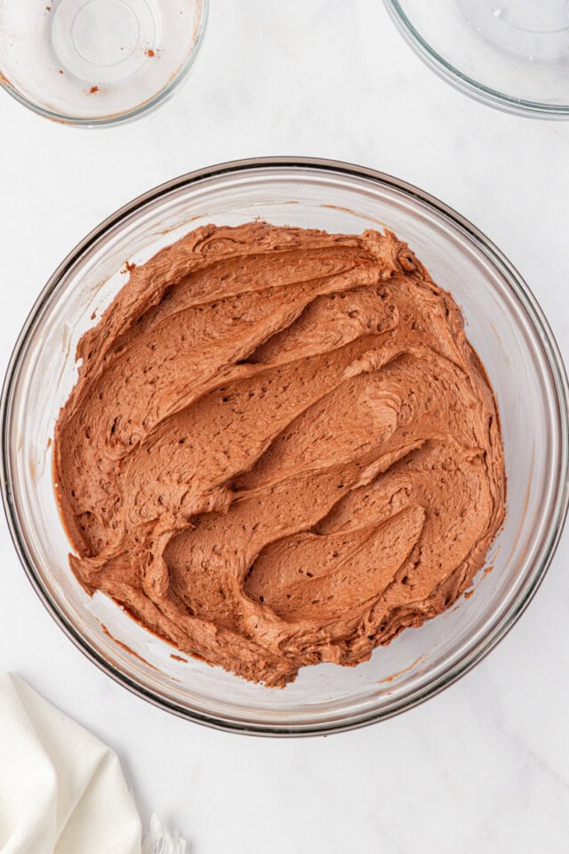 overhead view of chocolate buttercream frosting in a mixing bowl