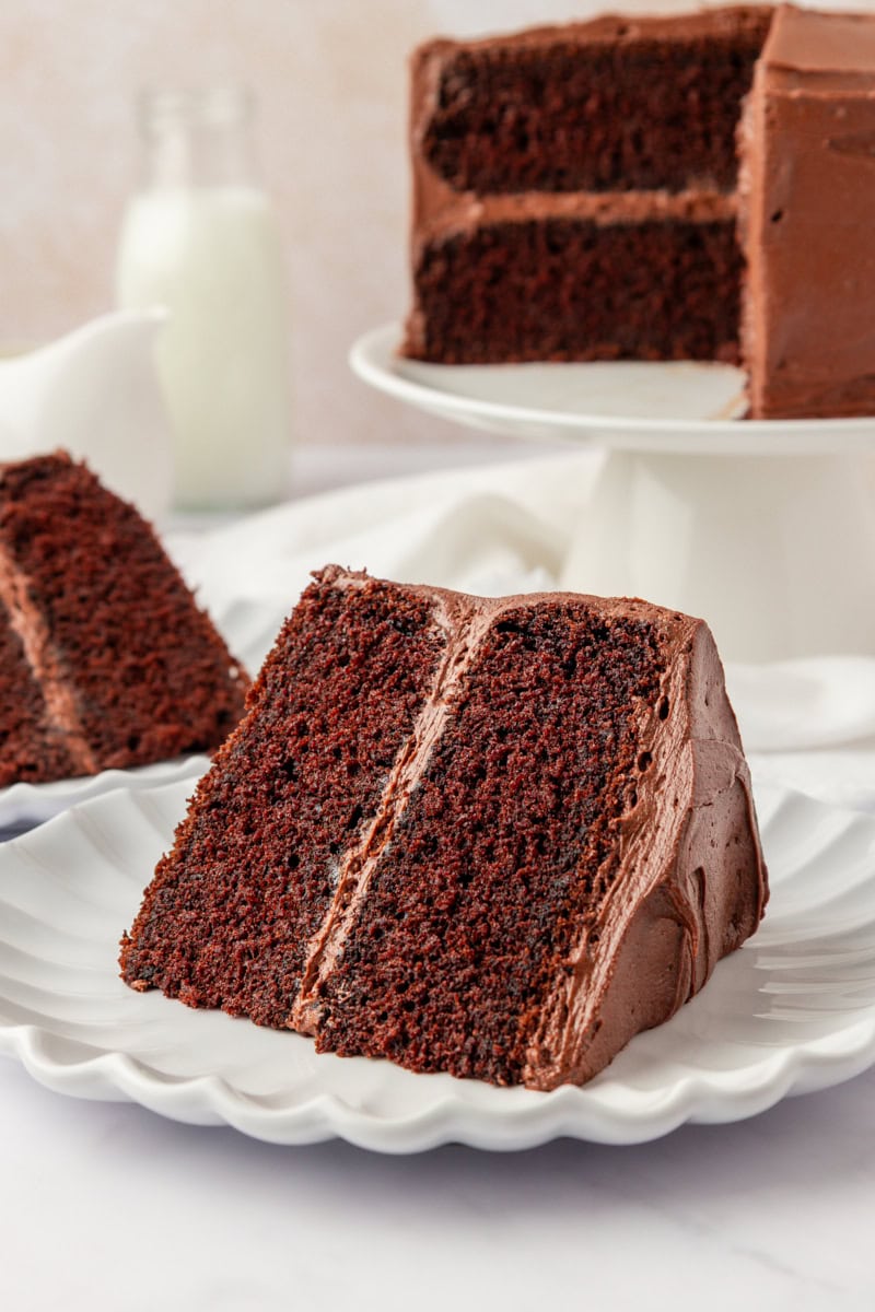 a slice of devil's food cake served on a white plate