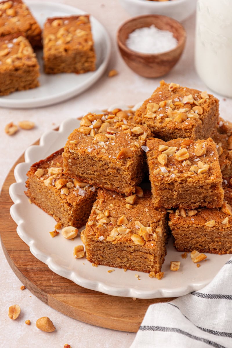 peanut butter blondies in a stacked pile on a white plate